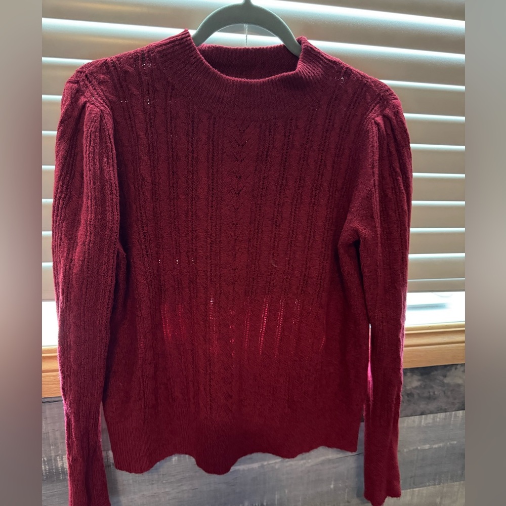 Dark red cable knit sweater.
